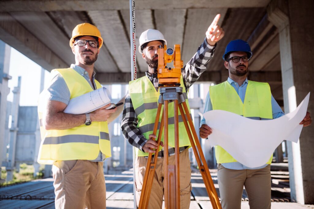 Portrait of construction engineers working on building site